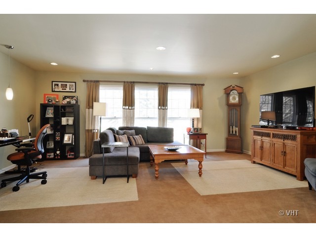 170 Cold Spring Road Barrington, IL 60010 - Photo 2 of 10 a living room with furniture a flat screen tv and a refrigerator