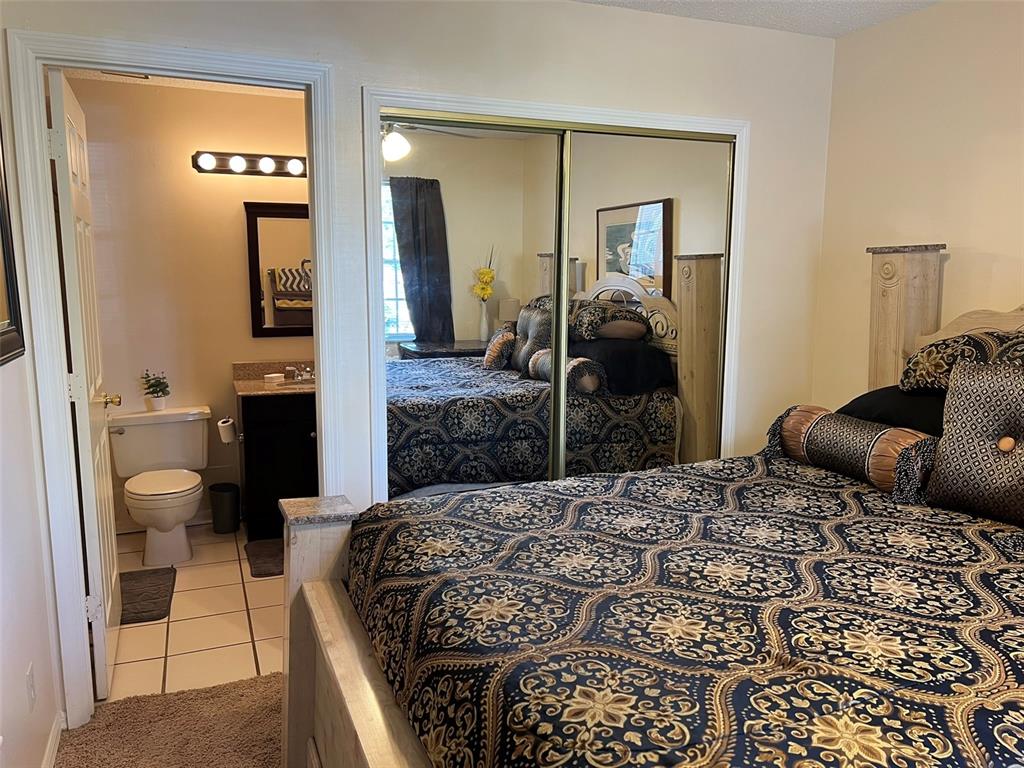 624 Cambridge Way, Unit 108 Altamonte Springs, FL 32714 - Photo 12 of 22 a bedroom with a bed and a mirror