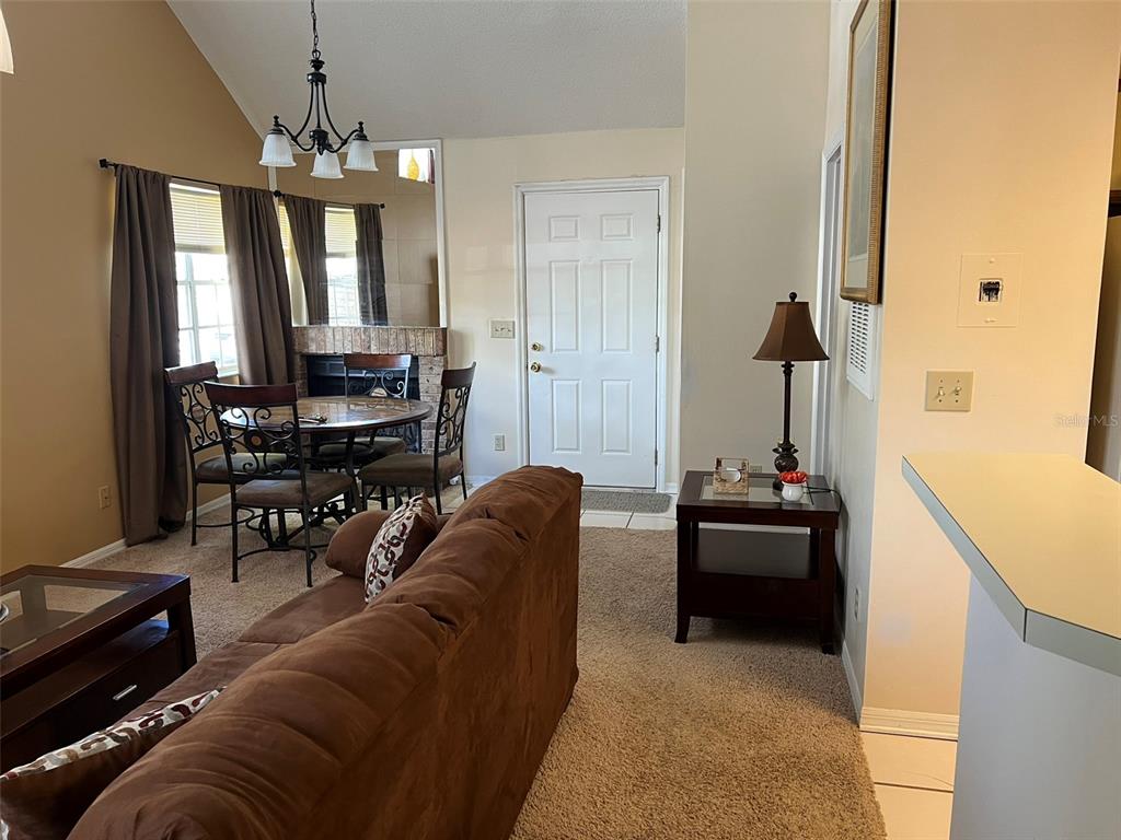 624 Cambridge Way, Unit 108 Altamonte Springs, FL 32714 - Photo 16 of 22 a living room with furniture and a chandelier