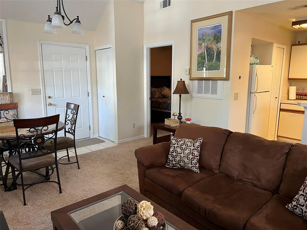624 Cambridge Way, Unit 108 Altamonte Springs, FL 32714 - Photo 17 of 22 a living room with furniture and a dining table