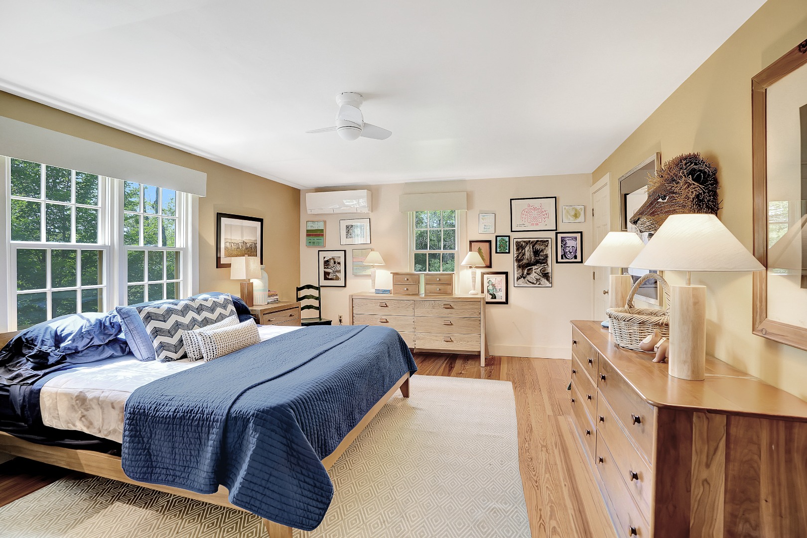 122 Old Farm Road Chilmark, MA 02535 - Photo 20 of 36 a spacious bedroom with a large bed and a chandelier
