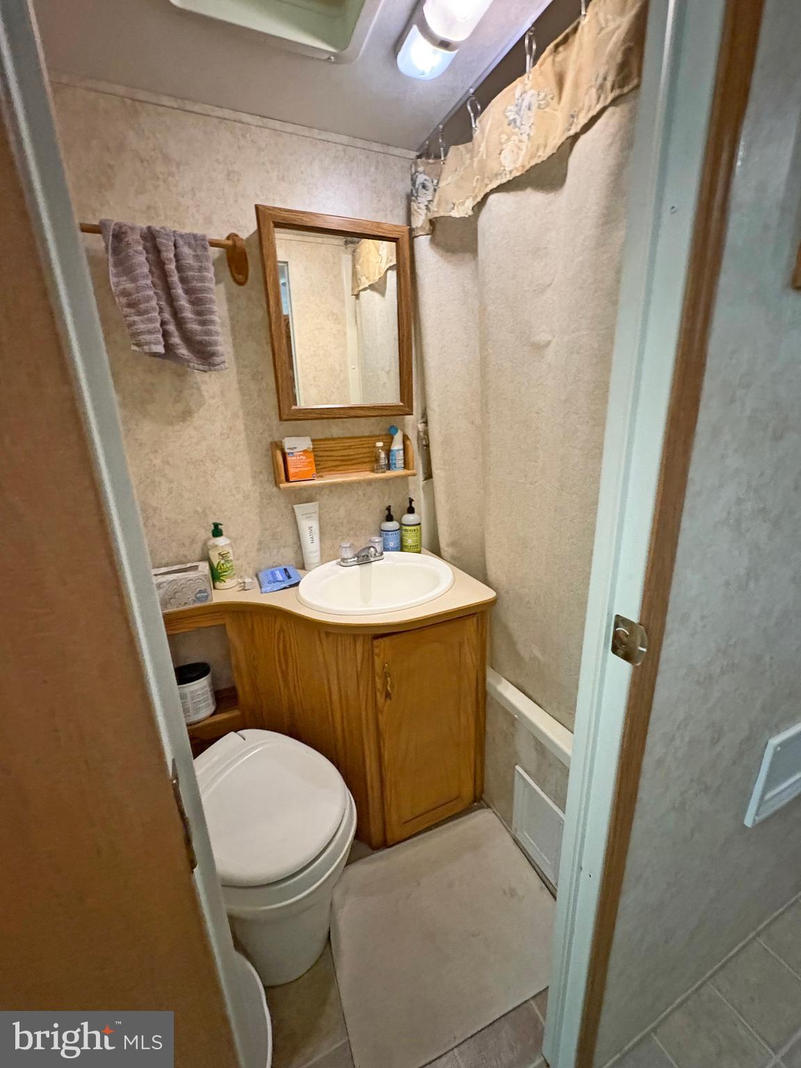 6-20 Boo Boo Boulevard Falling Waters, WV 25419 - Photo 11 of 16 a bathroom with a sink and a mirror