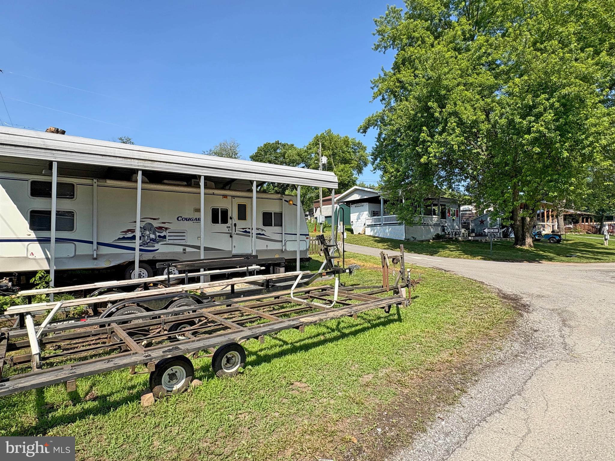 6-20 Boo Boo Boulevard Falling Waters, WV 25419 - Photo 4 of 16 a view of a house with backyard sitting area and garden
