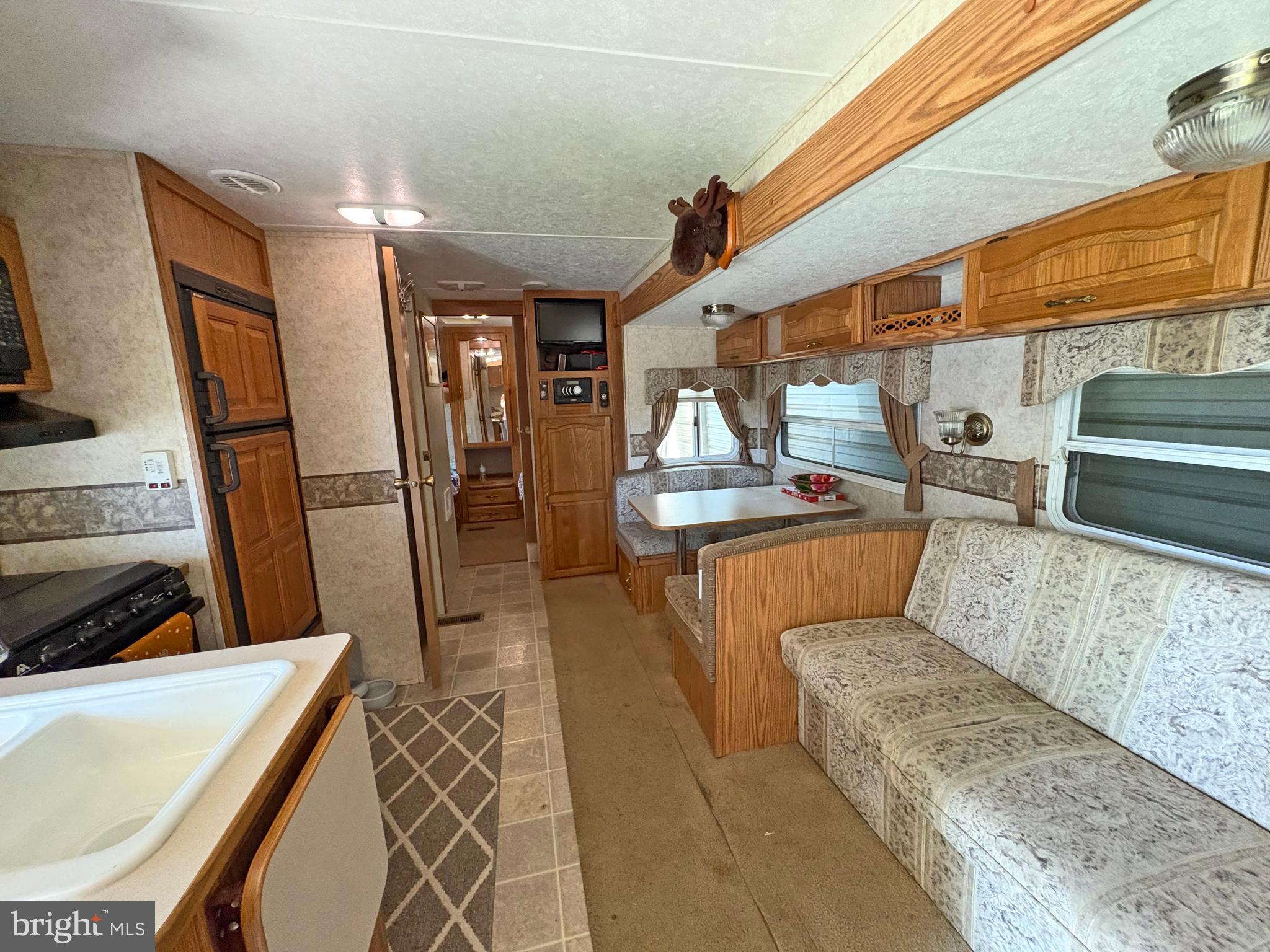 6-20 Boo Boo Boulevard Falling Waters, WV 25419 - Photo 6 of 16 a kitchen with stainless steel appliances kitchen island granite countertop a sink and cabinets