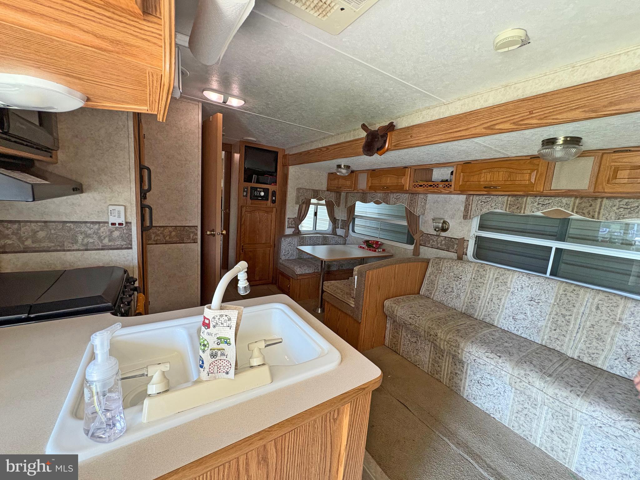 6-20 Boo Boo Boulevard Falling Waters, WV 25419 - Photo 7 of 16 a kitchen with stainless steel appliances kitchen island granite countertop a sink and a refrigerator