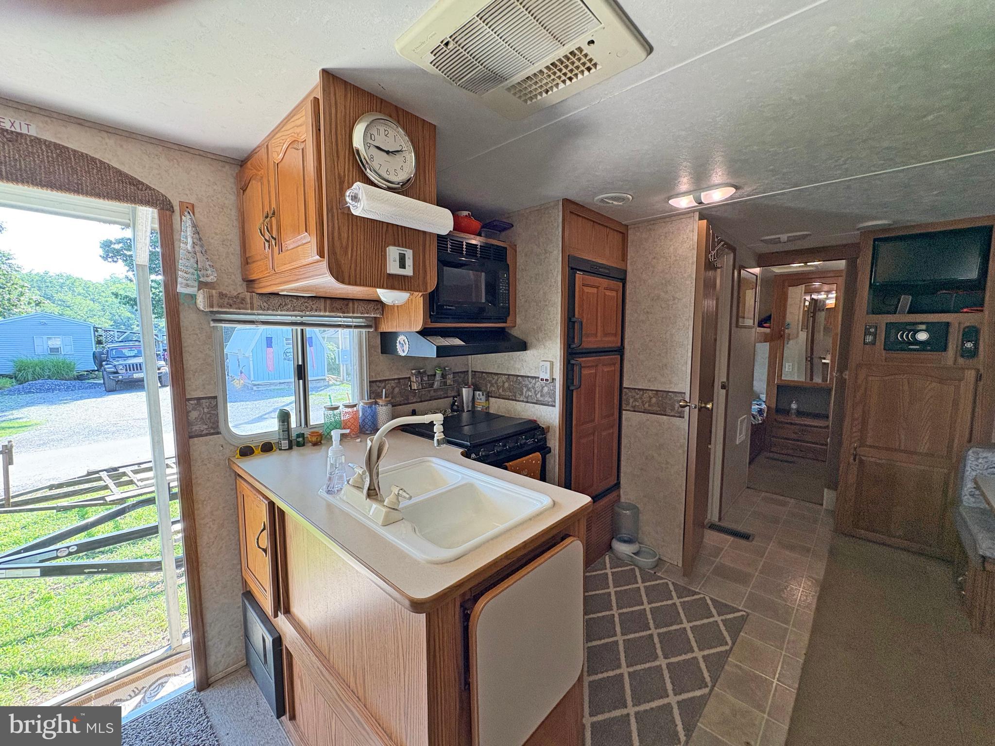 6-20 Boo Boo Boulevard Falling Waters, WV 25419 - Photo 9 of 16 a kitchen with stainless steel appliances granite countertop a sink and a refrigerator