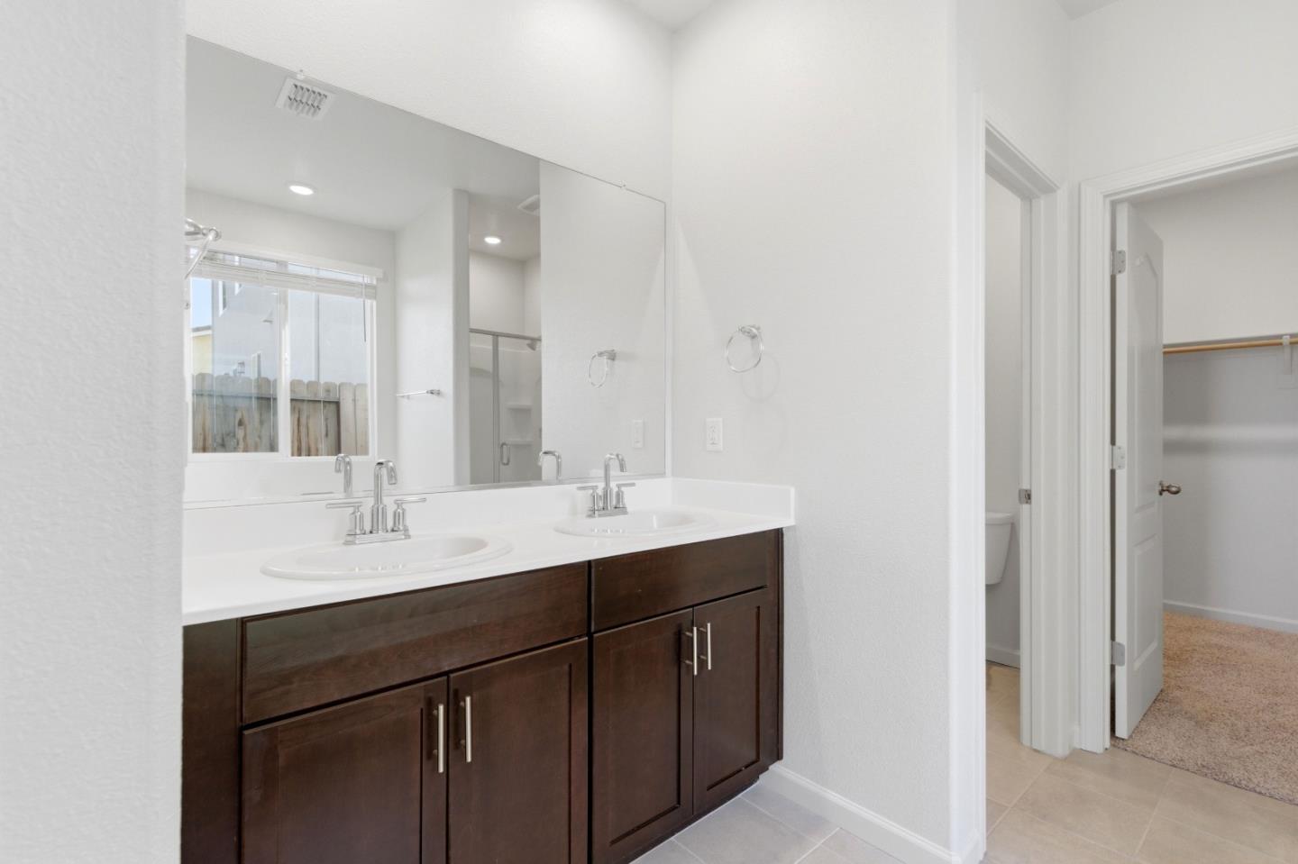 331 Lolly Way Los Banos, CA 93635 - Photo 11 of 31 a bathroom with a sink double vanity and a mirror