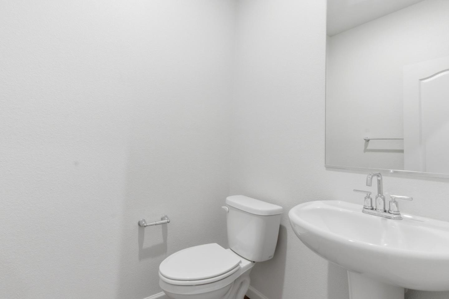 331 Lolly Way Los Banos, CA 93635 - Photo 15 of 31 a white toilet sitting next to a white sink