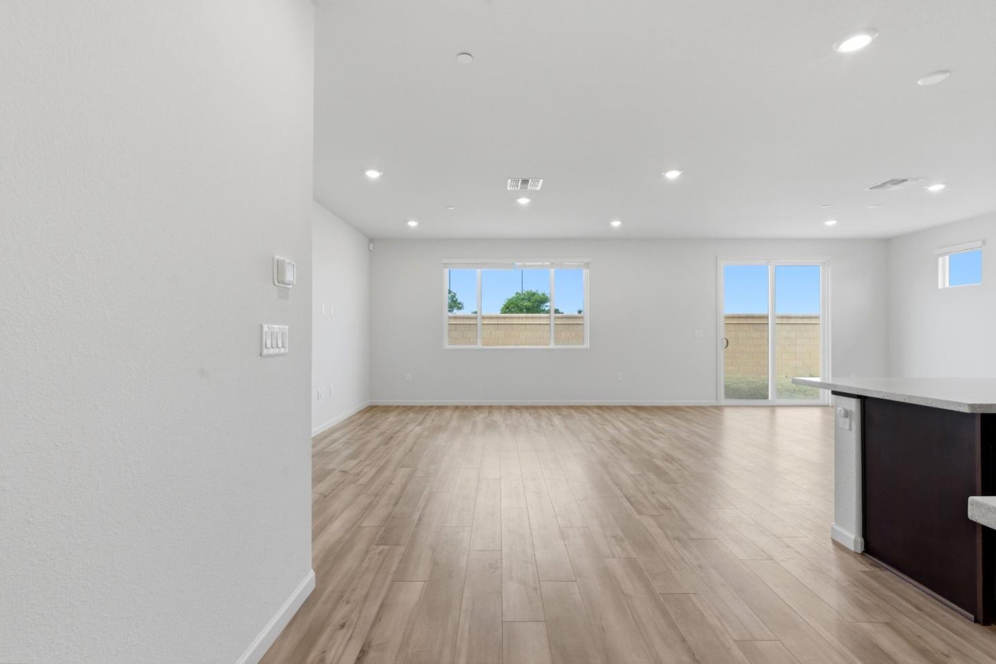 331 Lolly Way Los Banos, CA 93635 - Photo 17 of 31 an empty room with wooden floor and windows