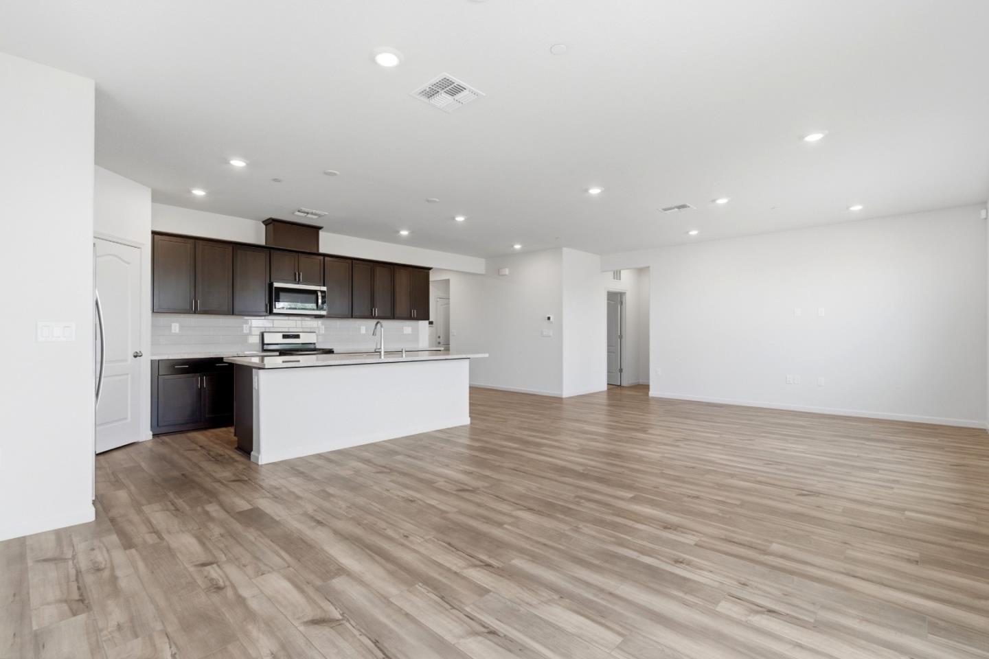 331 Lolly Way Los Banos, CA 93635 - Photo 19 of 31 a view of kitchen with granite countertop cabinets and white stainless steel appliances