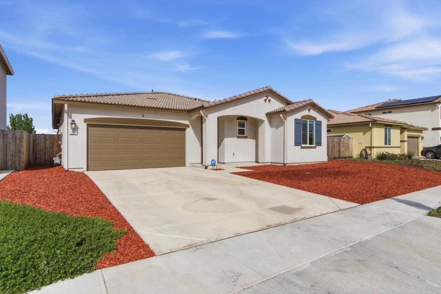 331 Lolly Way Los Banos, CA 93635 - Photo 2 of 31 a front view of a house with a yard and garage