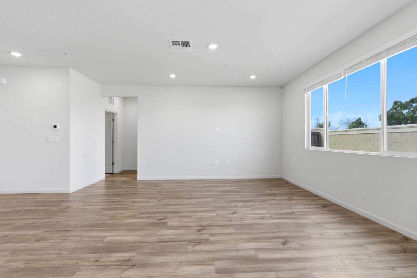 331 Lolly Way Los Banos, CA 93635 - Photo 25 of 31 a view of an empty room with wooden floor and a window