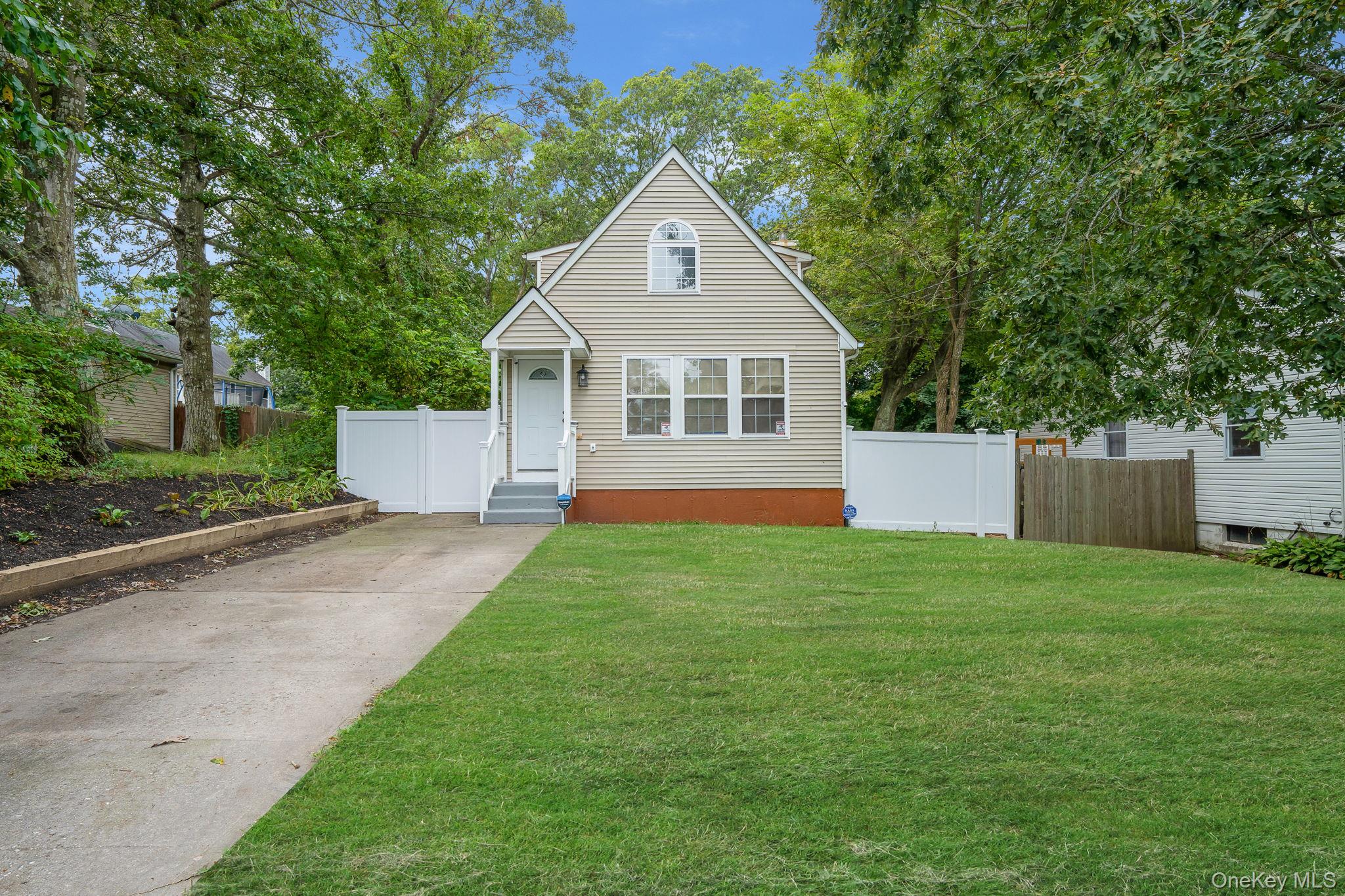 14 Hawthorne Street Mastic, NY 11950 - Photo 1 of 1 a view of an house with backyard space and garden