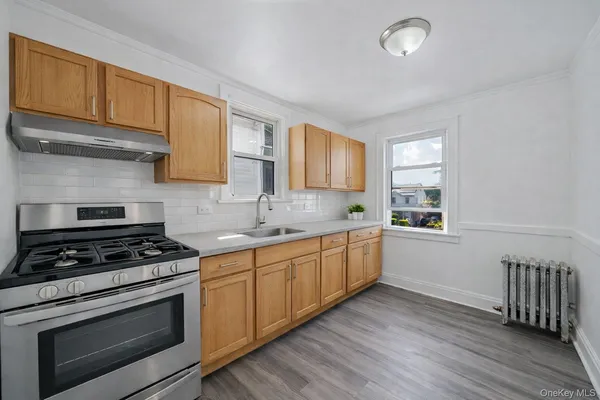 a kitchen with wooden floors and a stove