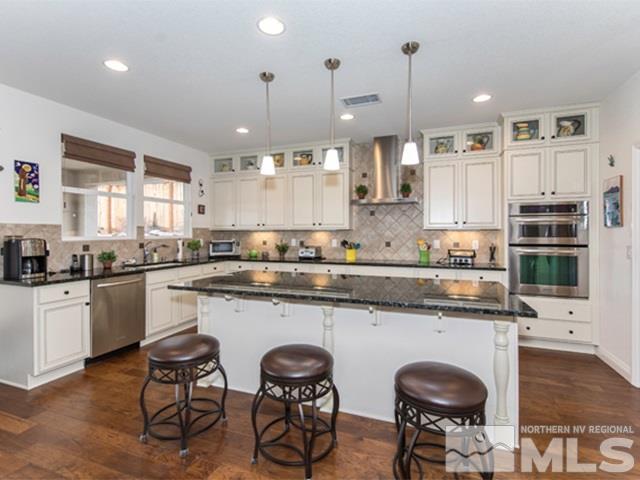 2035 Back Nine Trail Reno, NV 89523 - Photo 6 of 25 a kitchen with stainless steel appliances granite countertop white cabinets and wooden floor