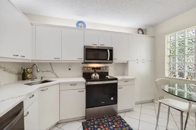 a living room with furniture a rug and a book shelf