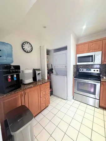 a kitchen with stainless steel appliances a stove a sink and a microwave