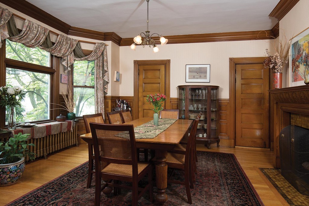 127 Naples Road Brookline, MA 02446 - Photo 4 of 11 a dining room with wooden floor a chandelier a wooden table and chairs