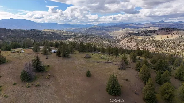 a view of a road with mountains in the background