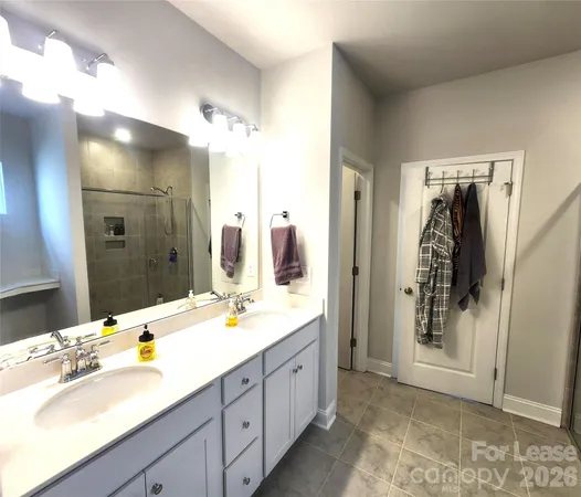 a spacious bathroom with a double vanity sink mirror and double