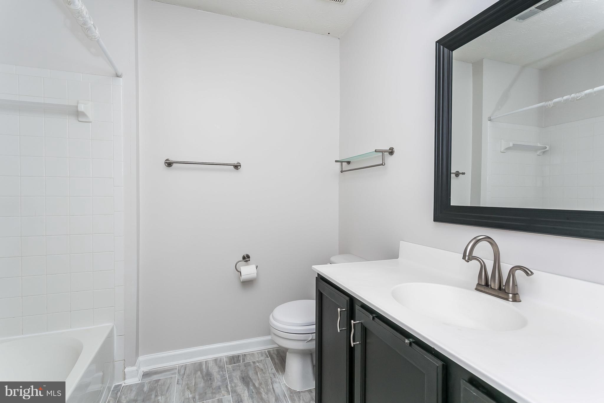 5143 Spring Willow Court Owings Mills, MD 21117 - Photo 18 of 29 Hall Bath with new flooring and mirror/lighting