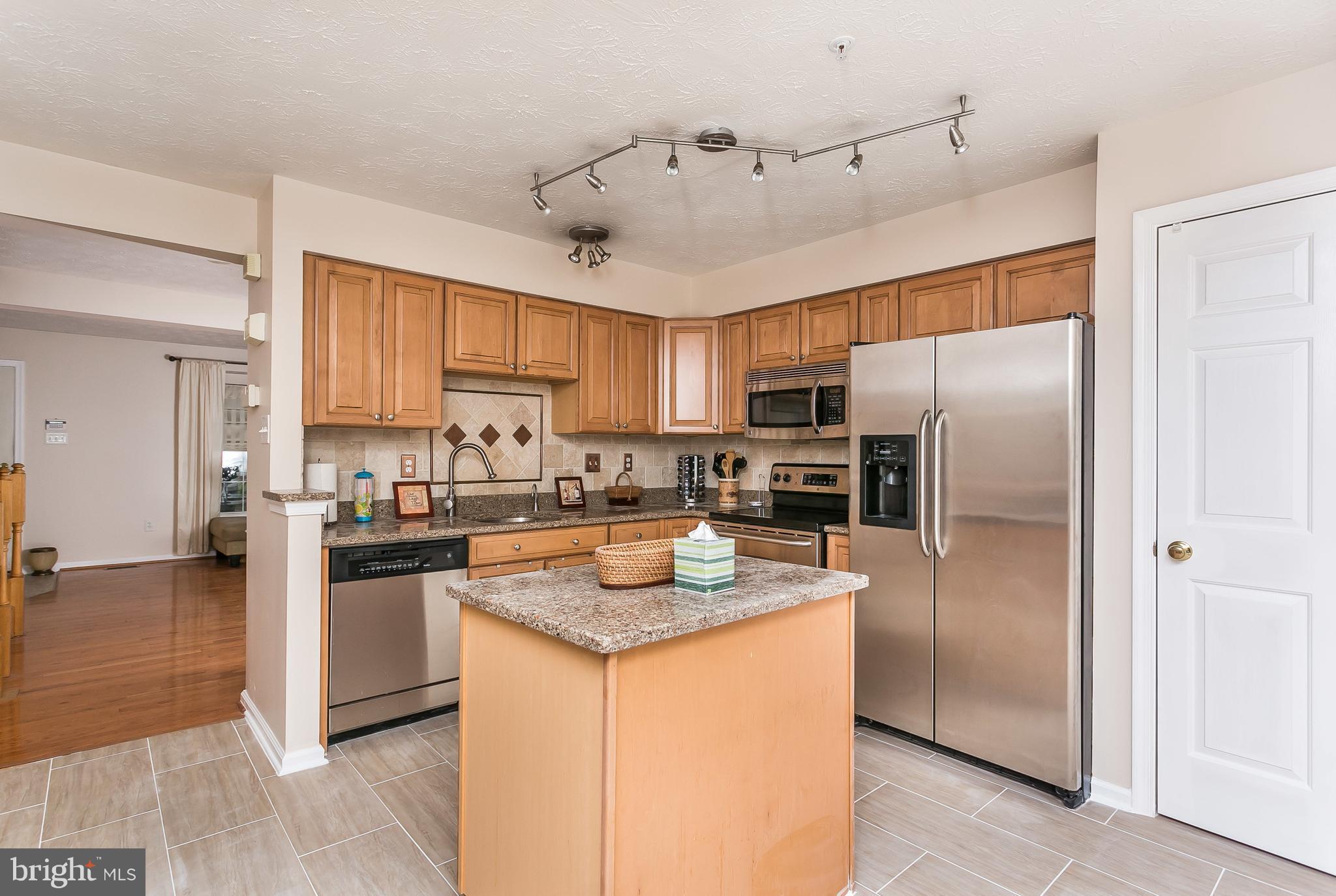 5143 Spring Willow Court Owings Mills, MD 21117 - Photo 7 of 29 With cooking island and Sunroom