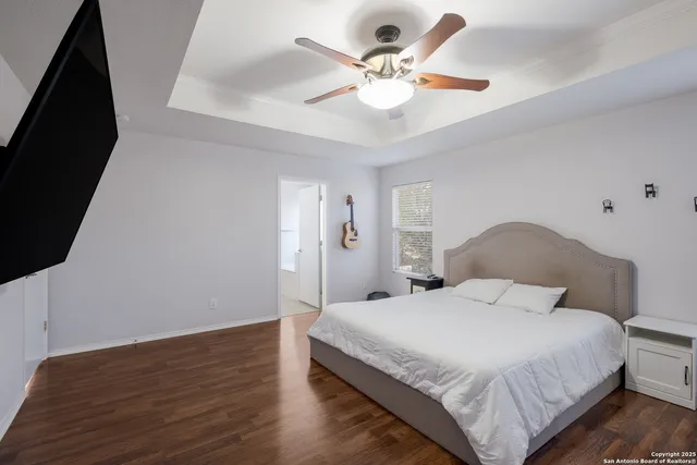 a bedroom with a large bed and a chandelier