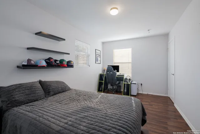 a bedroom with bed and a chandelier