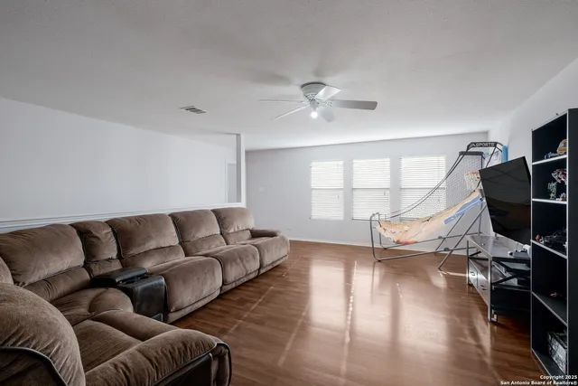 a living room with furniture and a wooden floor