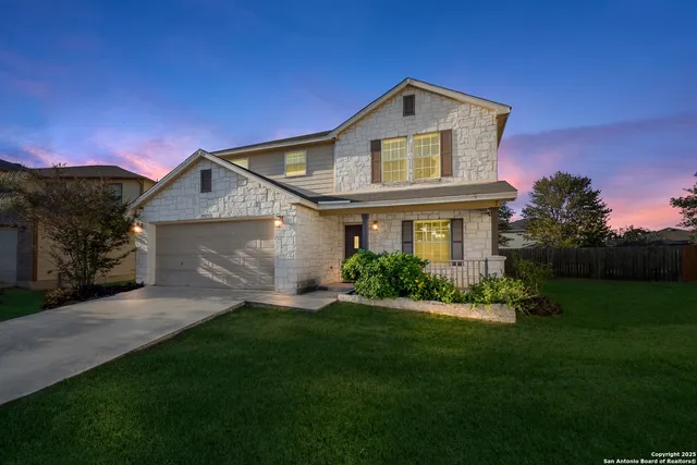 a front view of a house with a garden and yard