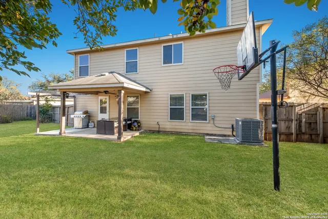 a view of a house with a yard and sitting area