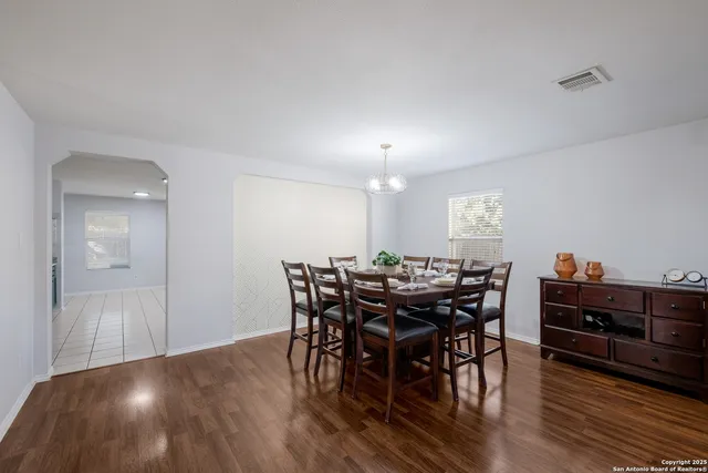 a view of a dining room with furniture and wooden floor