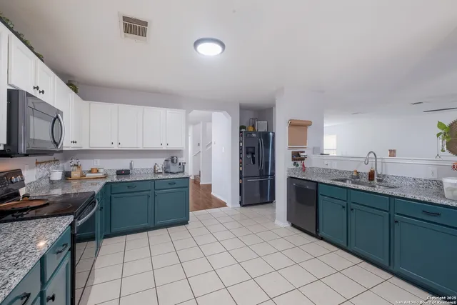 a kitchen with stainless steel appliances granite countertop a sink and stove top oven