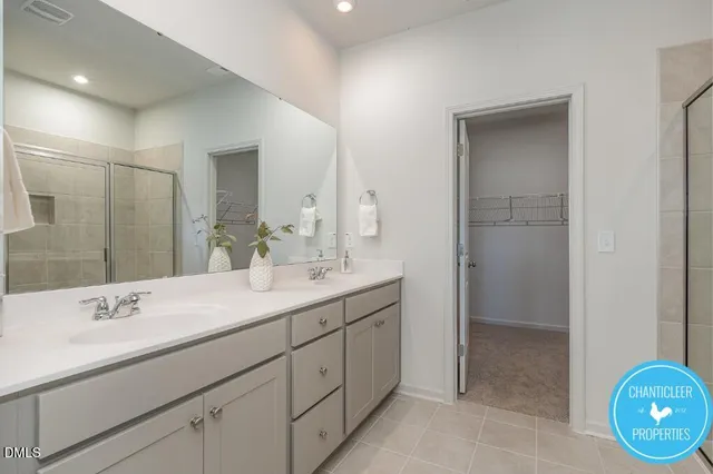 a bathroom with a double vanity sink and a mirror