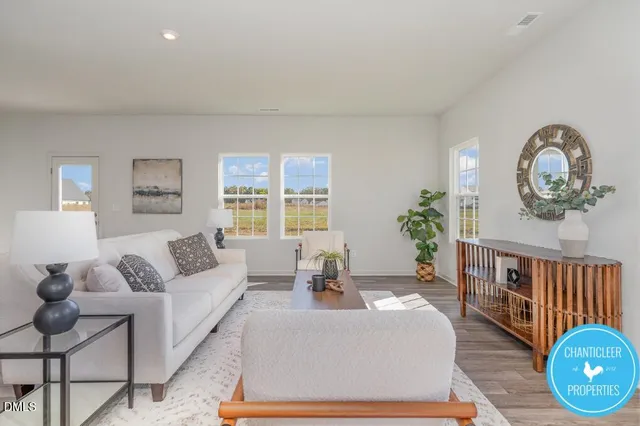 a living room with furniture a couch and a potted plant