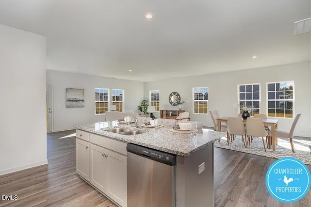 a open kitchen with a sink and breakfast area