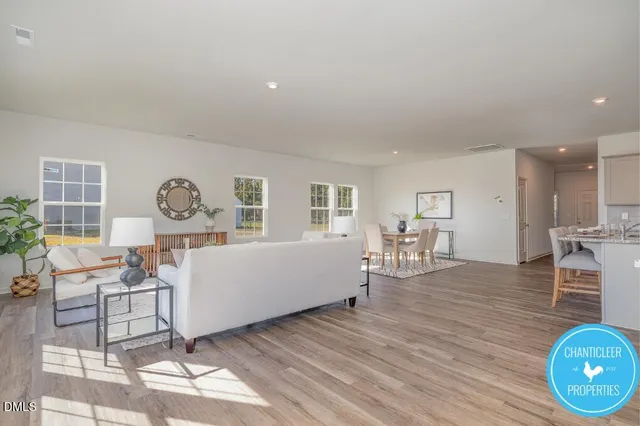 a living room with furniture a window and wooden floor