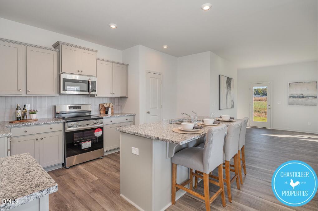 66705 Hardwick Lane Sims, NC 27880 - Photo 8 of 18 a kitchen with stainless steel appliances kitchen island granite countertop a sink and cabinets