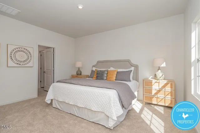 a bedroom with a bed and painting on the wall