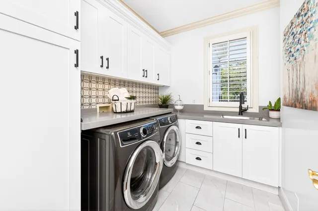 a view of washer and dryer with kitchen in the background