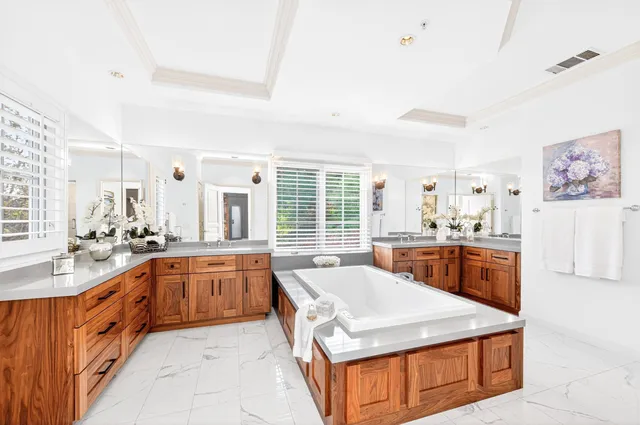 a large kitchen with kitchen island a sink stove and refrigerator