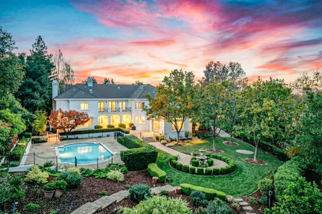 a view of a garden with a house in the background