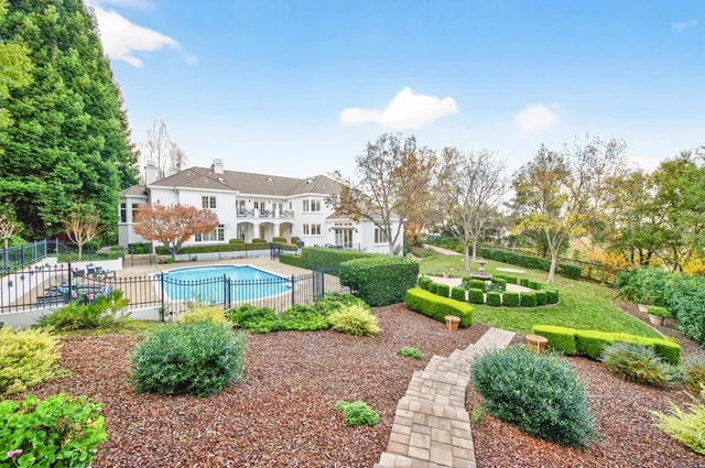 a view of a house with a yard and plants