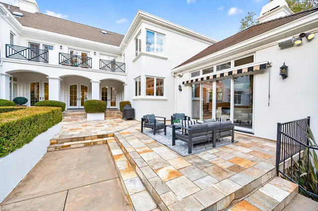 a view of a house with backyard porch and sitting area