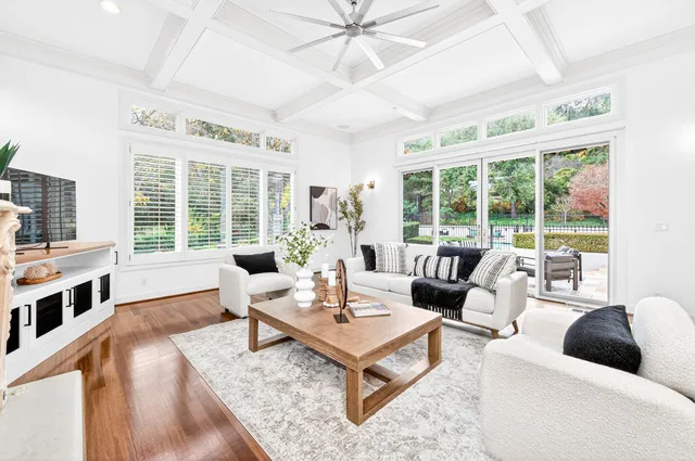 a living room with furniture and large windows