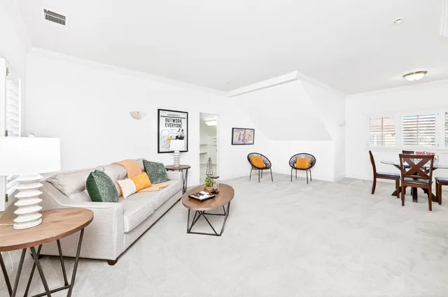 a living room with furniture and wooden table