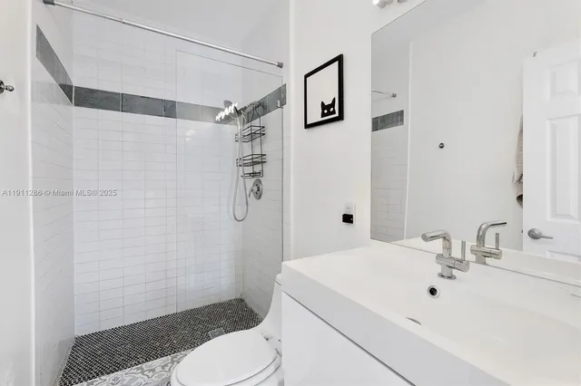 a bathroom with a sink toilet and shower