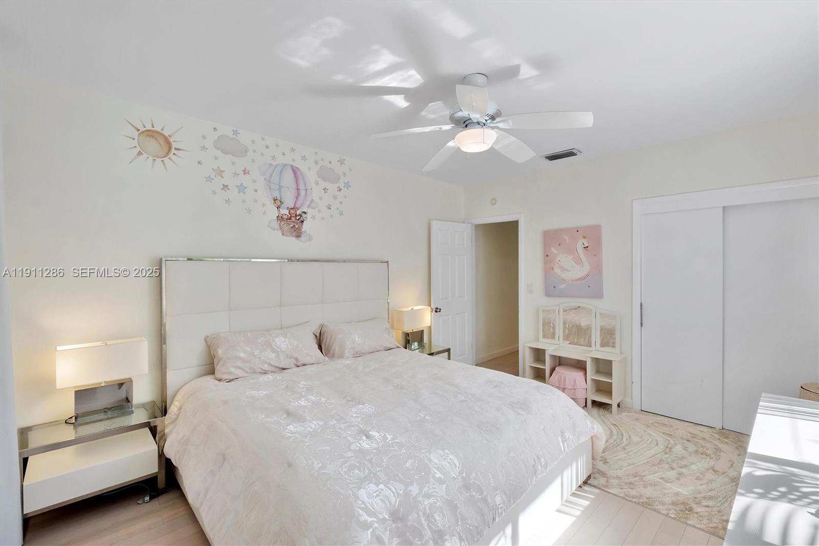 9049 Dickens Avenue Surfside, FL 33154 - Photo 17 of 34 a bedroom with a bed and a chandelier