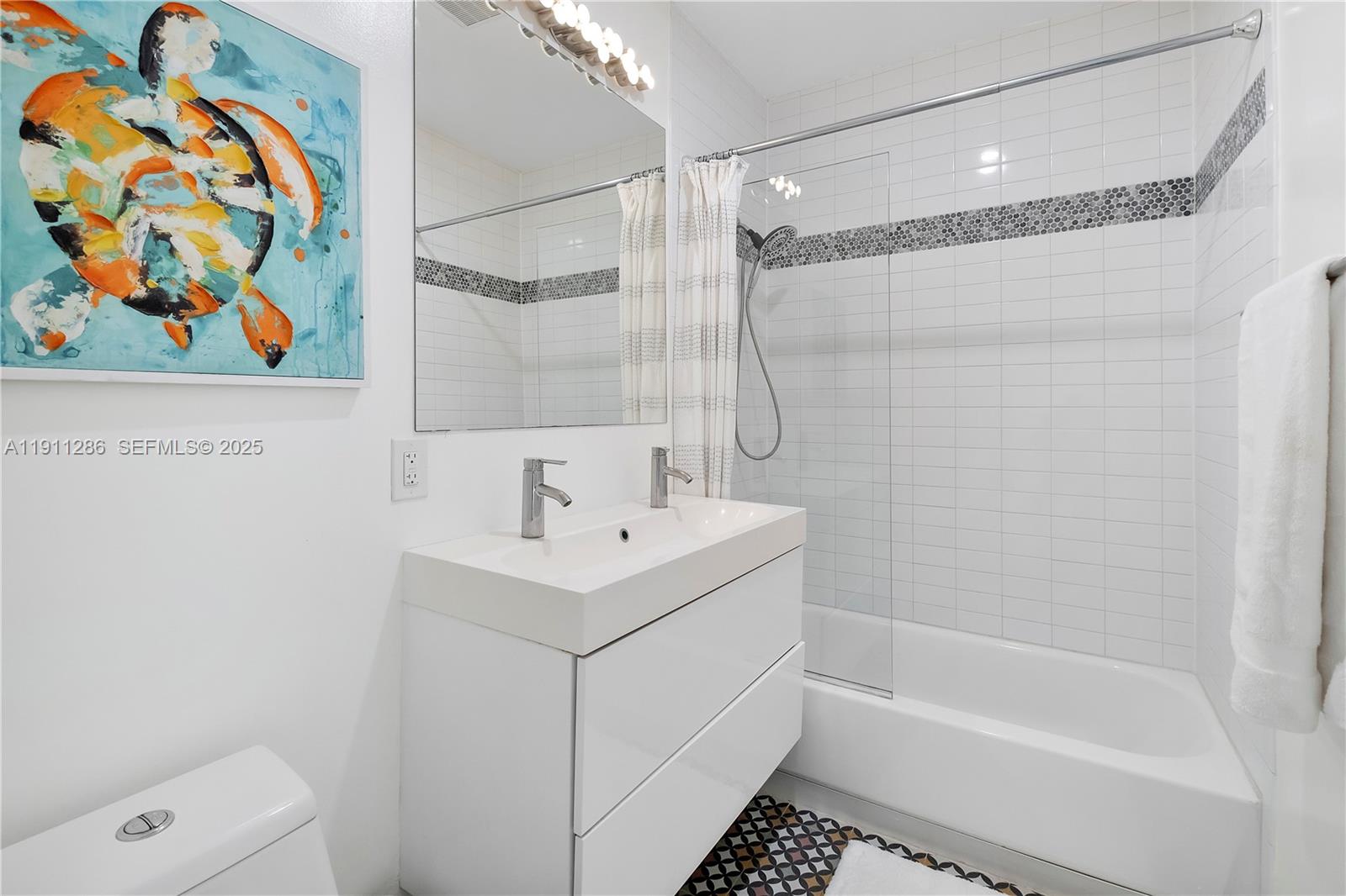 9049 Dickens Avenue Surfside, FL 33154 - Photo 19 of 34 a bathroom with a sink a toilet and a bathtub