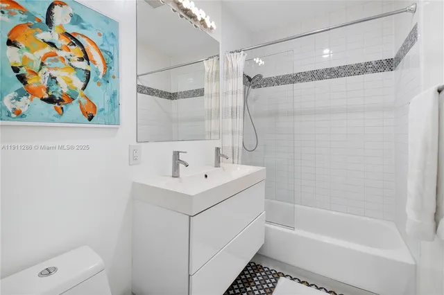 a bathroom with a sink a toilet and a bathtub